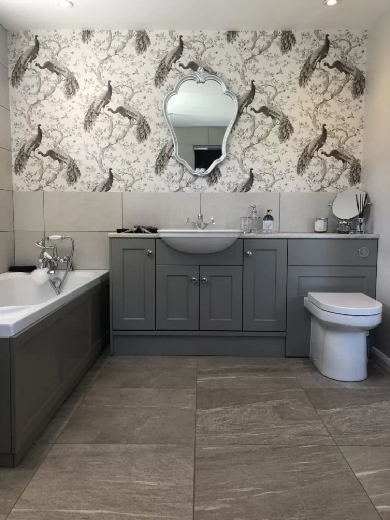 Peacock wallpaper and dark grey vanity units in bathroom